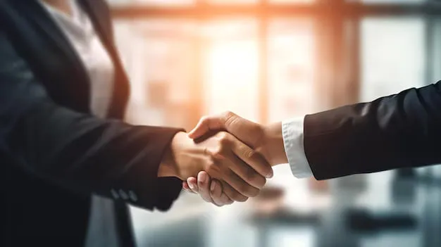 Une poignée de main entre deux professionnels en tenue de travail.